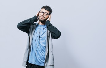 People enjoying music with headphones isolated. Cheerful guy listening to music with mobile phone