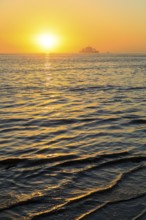 Ferry and sunset on the west coast of Norderney, Lower Saxony, Germany