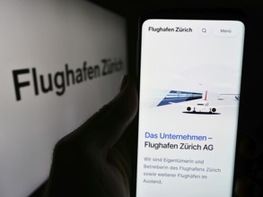 Stuttgart, Germany, 05-31-2024: Person holding smartphone with website of Swiss airport operator