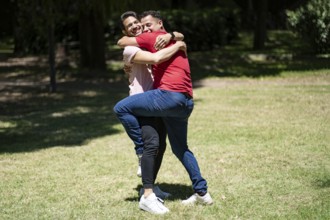 Couple of latin men hugging in a park