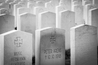 A black and white photo of a First World War military cemetery with rows of gravestones and