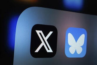 A close up of an iPad screen displaying the x and bluesky app
