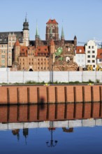 Old Town of Gdansk skyline in Poland, embankment water reflection on Old Motlawa River