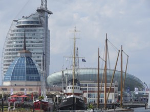 Ships and tall modern buildings in the harbour area under a cloudy sky, bremerhaven, bremen,