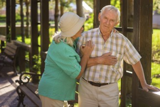 Senior man has heart ache. Elderly couple outside. I feel pains again. Husband has chronic illness