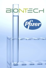 A single syringe, corona vaccine from Biontech and Pfizer, logo, test tubes, laboratory examination