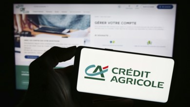 Stuttgart, Germany, 11-16-2023: Person holding smartphone with logo of French financial services