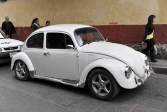 San Christobal de las Casas, Mexico, Central America, White VW Beetle classic model parked on a