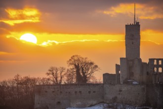 Königstein castle ruins at sunset. Viewpoint with a view over a village to a ruin in winter.
