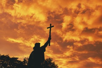 St Boniface statue at sunset, orange sky, Fulda, Germany