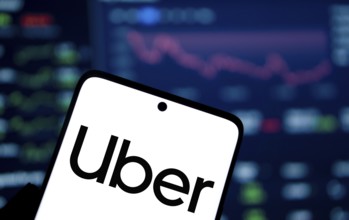 uber logo is displayed on smartphone. Uber Technologies, Inc. is an American multinational