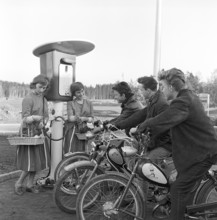 Teenagers of the 1950s. Three teenage boys at the petrol station that is being opened for the first