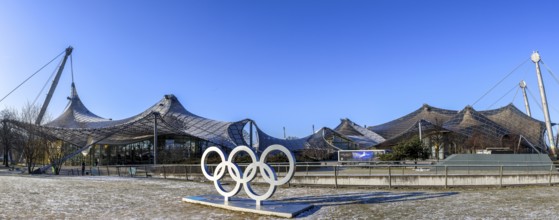 Panoramic photo of the sculpture of the Olympic rings and in the background the Olympic site with
