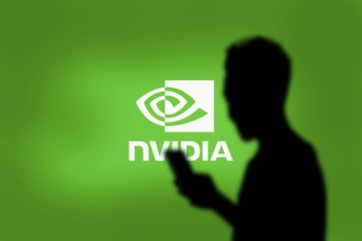 Nvidia logo on smartphone screen with AI in the background. Nvidia Corporation is an American