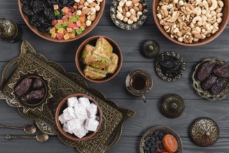 Homemade turkish delight baklava dates dried fruits nuts metallic earthen bowl table. High
