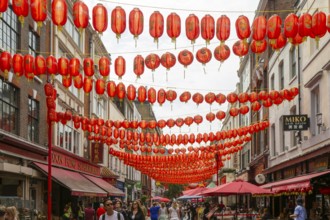Red Chinese lanterns crossing above Gerrard Street, Chinatown, West End, London, England, UK