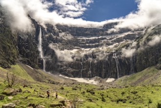 Hikers in the cloudy Cirque de Gavarnie basin, UNESCO World Heritage Site in the Pyrenees National