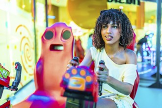 Young woman enjoying a vibrant day at the mall, immersed in the excitement of playing an arcade