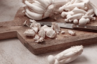 Freshly sliced Shimizhi mushrooms, on a wooden chopping board, ready to cook, close-up, no people