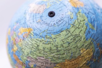 Puzzle globe. Map made from puzzle pieces. Russia and North Pole