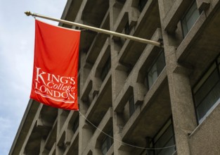 Red flag banner hanging from building Strand Campus, King's College university, London, England, UK