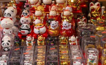 Waving lucky cats and pandas souvenirs, Chinatown, West End, London, England, UK