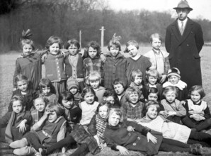 School outing girls class teacher, 1920, group of school children and a teacher outdoors with