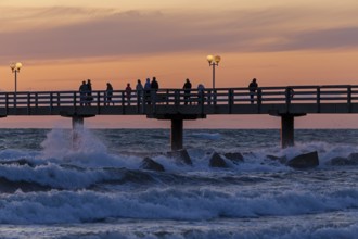 Sunset, pier, people, silhouettes, waves, swell, spray, street lamps, Wustrow, Fischland,