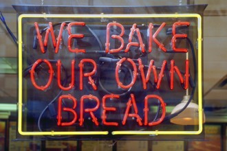 Illuminated advertising for a bakery, New York City, USA