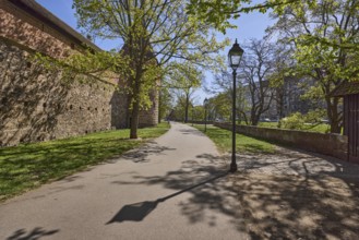 Old town, city fortification, city wall, footpath, trees, lawn, lantern, backlight, shadow, blue