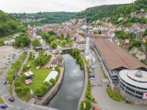 A river runs through the cityscape with a Ferris wheel and environmentally friendly surroundings,