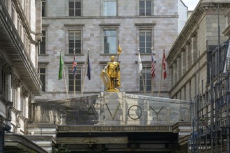 Count Peter of Savoy golden figure above entrance to The Savoy hotel, Strand, central London,