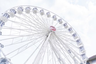 Beautiful Ferris wheel with illuminated gondolas in front of a clear sky, Ferris wheel