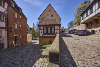 Residential building, historic half-timbered houses, sandstone wall, lantern, cobblestones, trees,