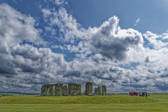 A group of tourists visits Stonehenge. The stone circle, a National Trust, UNESCO World Heritage