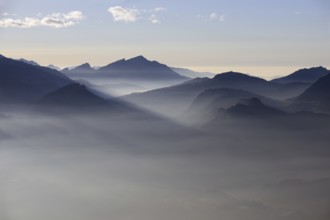 Mountain silhouettes... Alpine peaks and mountain ranges in the Bavarian Alps, light fog rises from