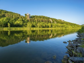 Prunn Castle on a steep cliff above the Altmühl Valley in the evening light, reflection in the