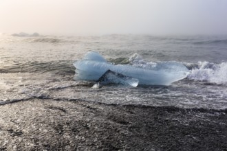 Melted iceberg, ice crystal on the beach, Diamond Beach in summer, haze, Jökulsárlón, Jökulsarlon,