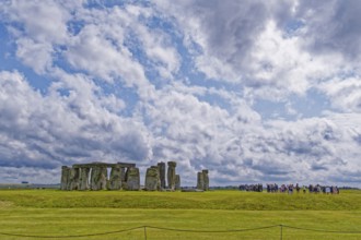 A group of tourists visits Stonehenge. The stone circle, a National Trust, UNESCO World Heritage