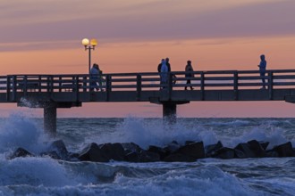 Sunset, pier, people, silhouettes, waves, swell, spray, street lamps, Wustrow, Fischland,