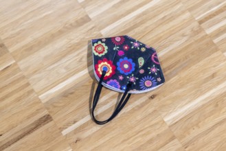 Protective mask during the pandemic. Colourful corona mask lying on the floor. Stuttgart,