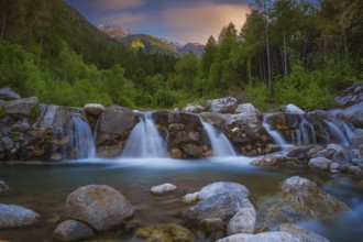 View of a waterfall of the Rio Plima stream in the evening light, long exposure, landscape photo,