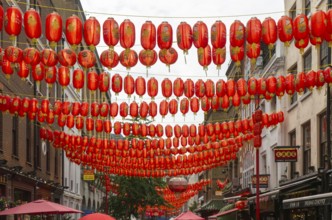 Red Chinese lanterns crossing above Gerrard Street, Chinatown, West End, London, England, UK
