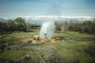 Fountain, in the background Kaukasus mountain range, Ochamchira, Abkhazia, Georgia