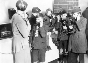 Children experimenting with telecommunication, group of children with telephones in a historical