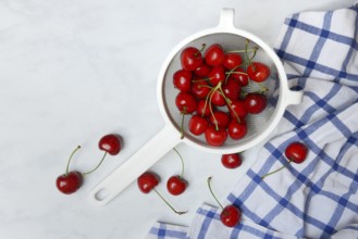 Sweet cherries in sieve, Prunus avium, bird cherry