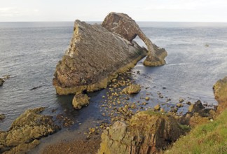 Impressive coastal view of a rock formation reaching far into the sea, Bow Fiddle Rock,