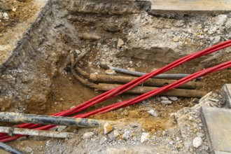 Underground cables and pipes under road surface, London, England, UK