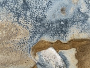 Abstract saline patterns at the edge of the Walvis Bay salt works. Aerial view. Drone shot. Namibia