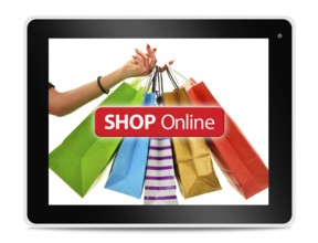 Paper shopping bags on computer tablet screen. Shopping online. E-commerce